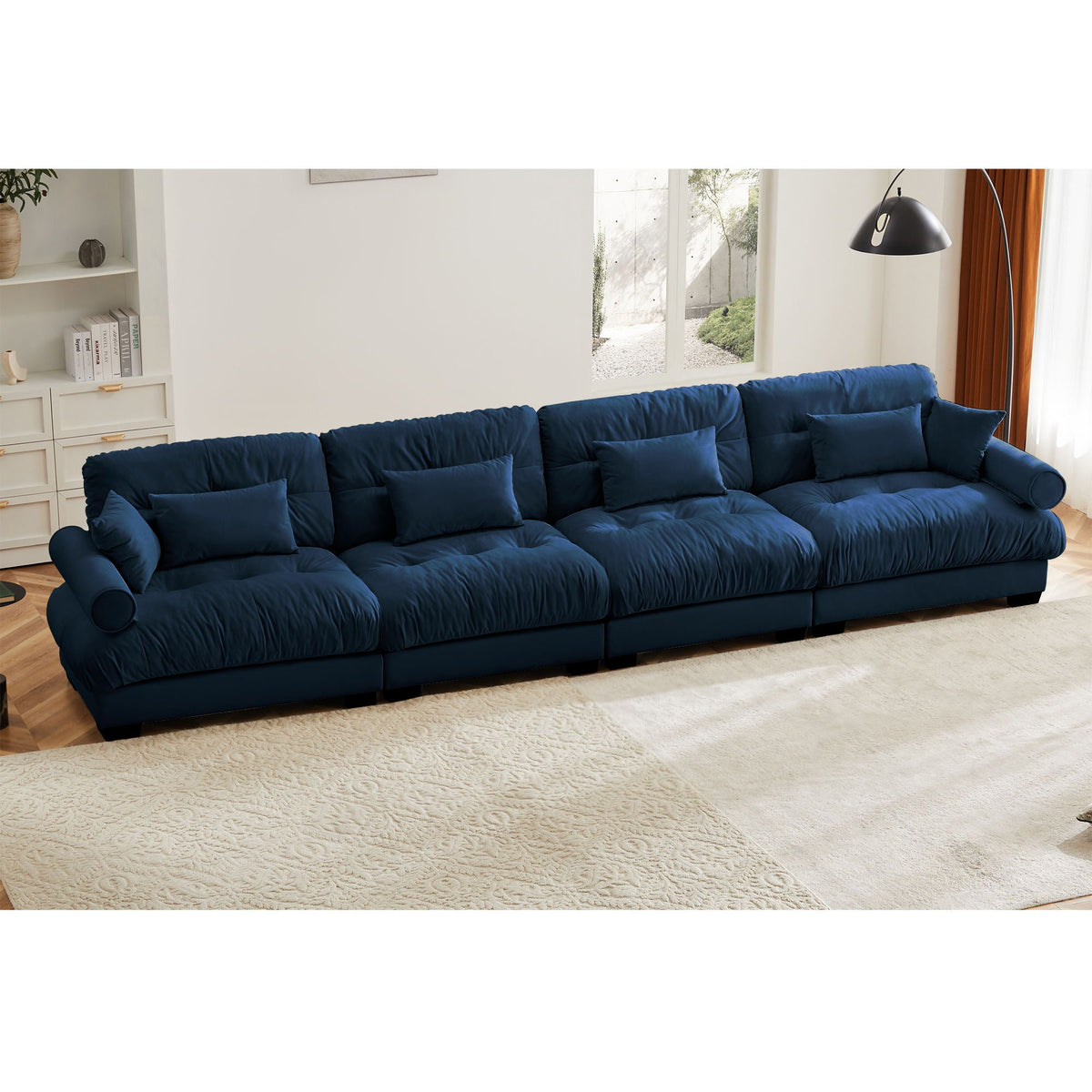 Blue modular L-shaped sectional sofa with deep seats and rounded bolster arm