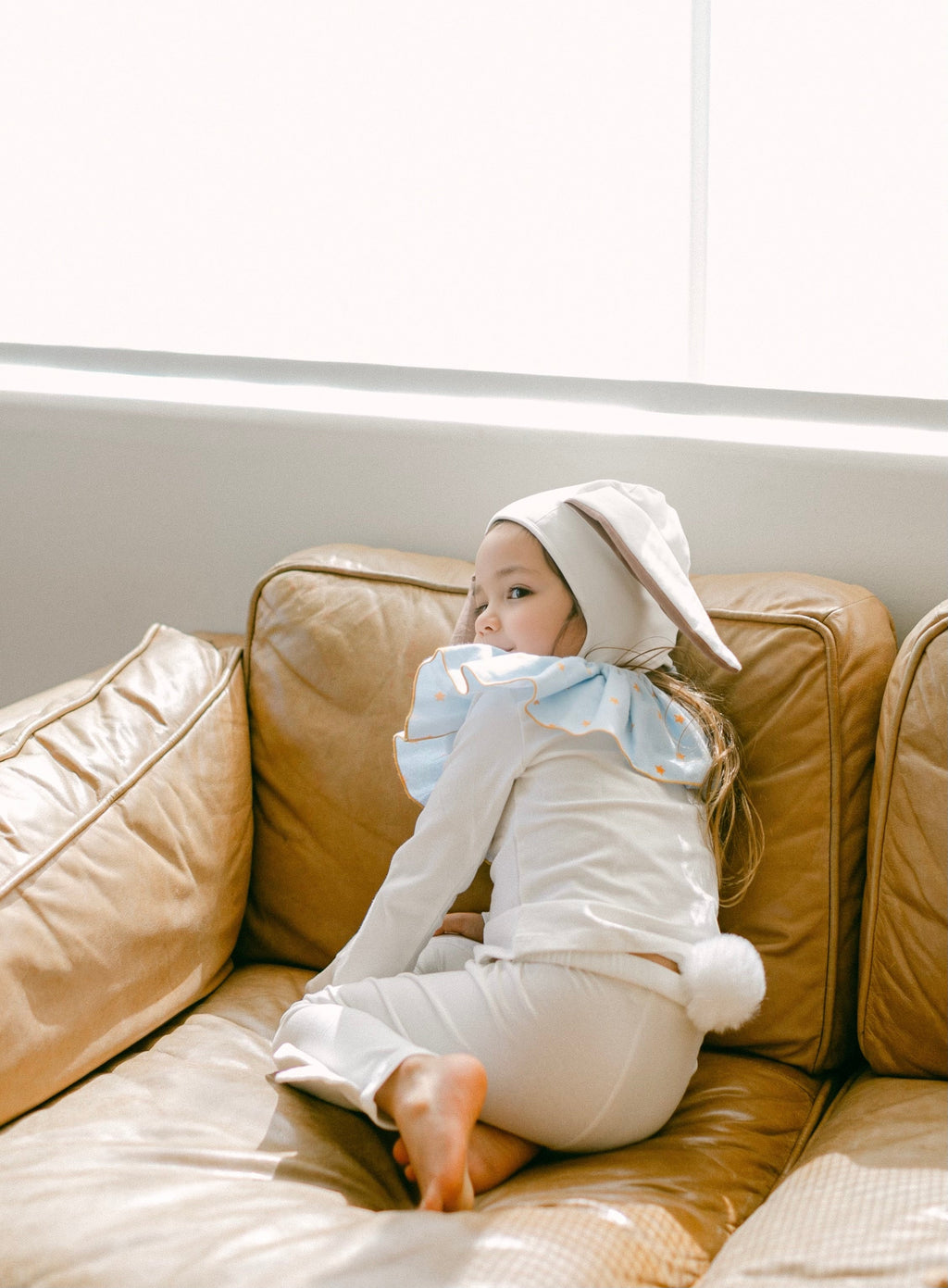 White bunny costume with blue star ruffle collar and floppy long-ear hood
