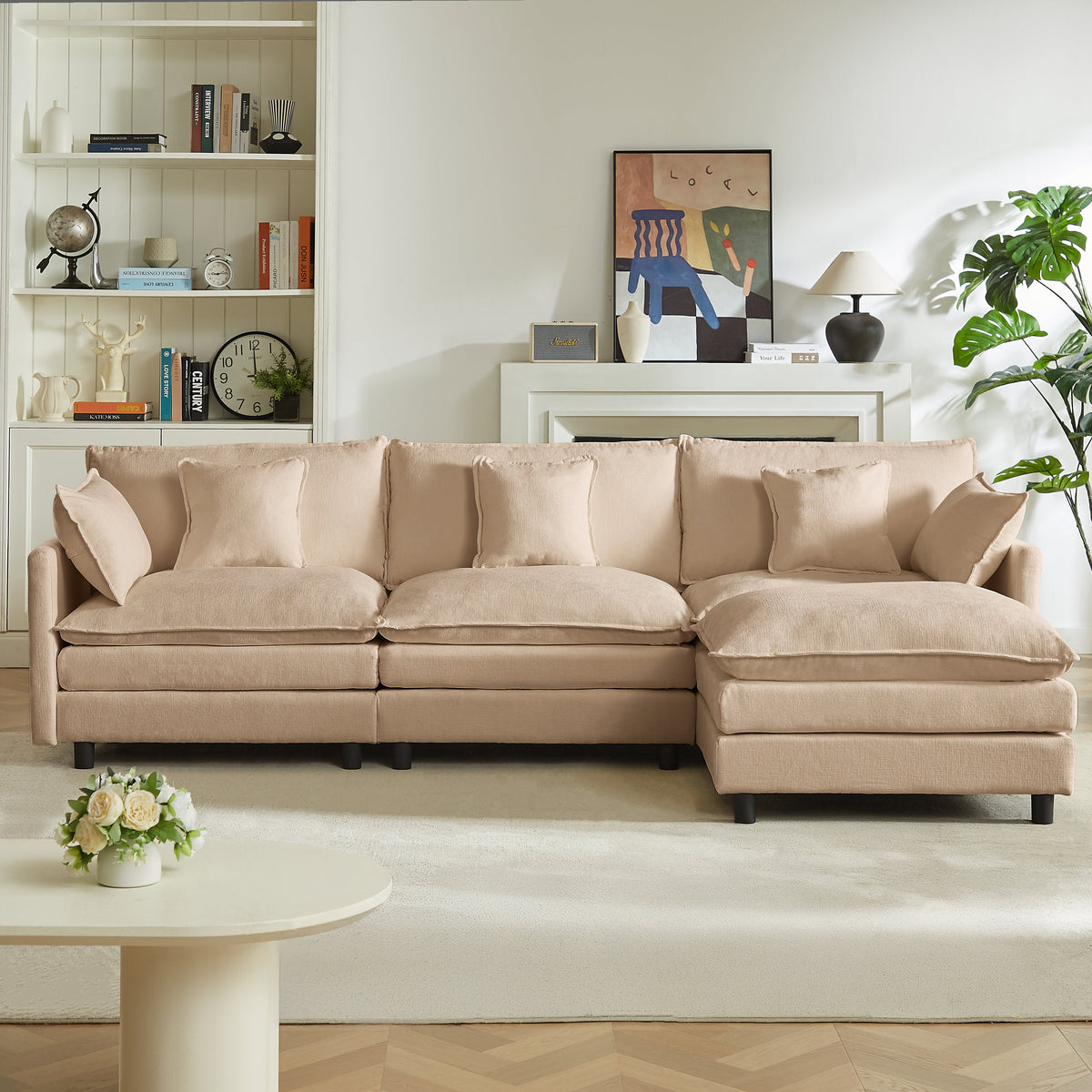 Beige sectional sofa with long chaise, five square pillows and one accent cushion.