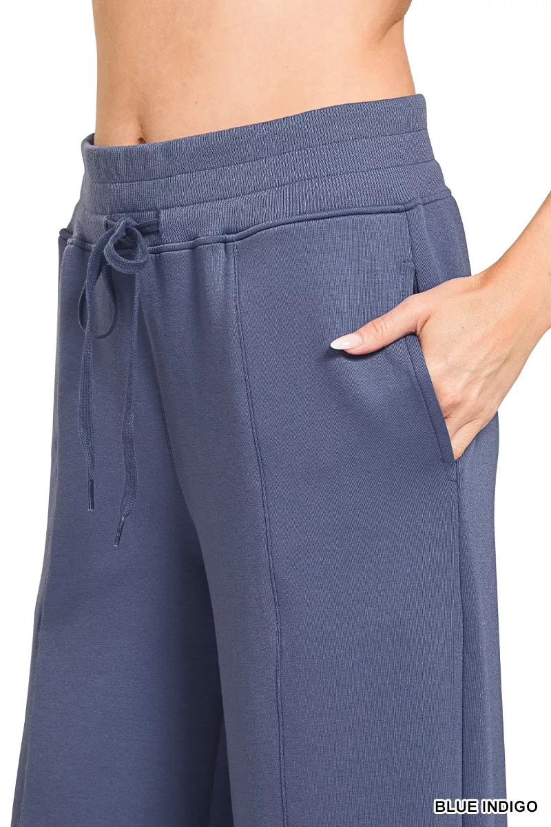 Blue indigo wide-leg pants close-up: elastic waist and drawstring ties