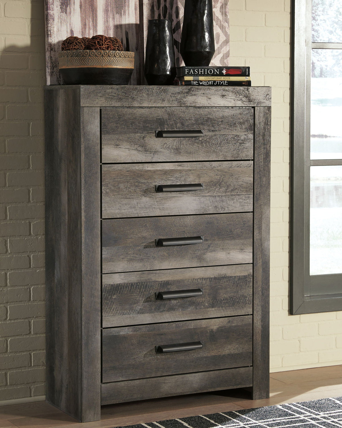 Gray wood dresser with five drawers and rectangular wall mirror
