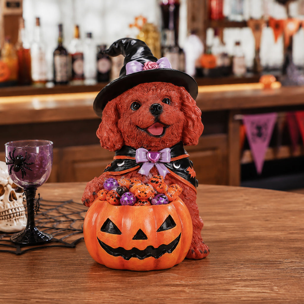 Brown puppy Halloween figurine in a witch hat with a pumpkin candy bowl