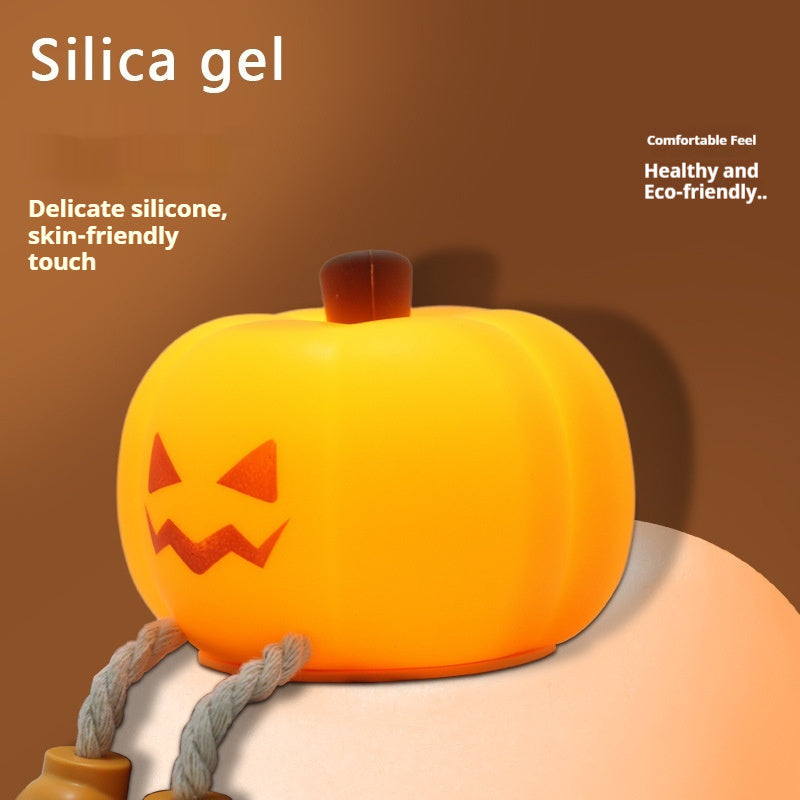 Pumpkin silicone night light with jack-o'-lantern face, warm glowing light