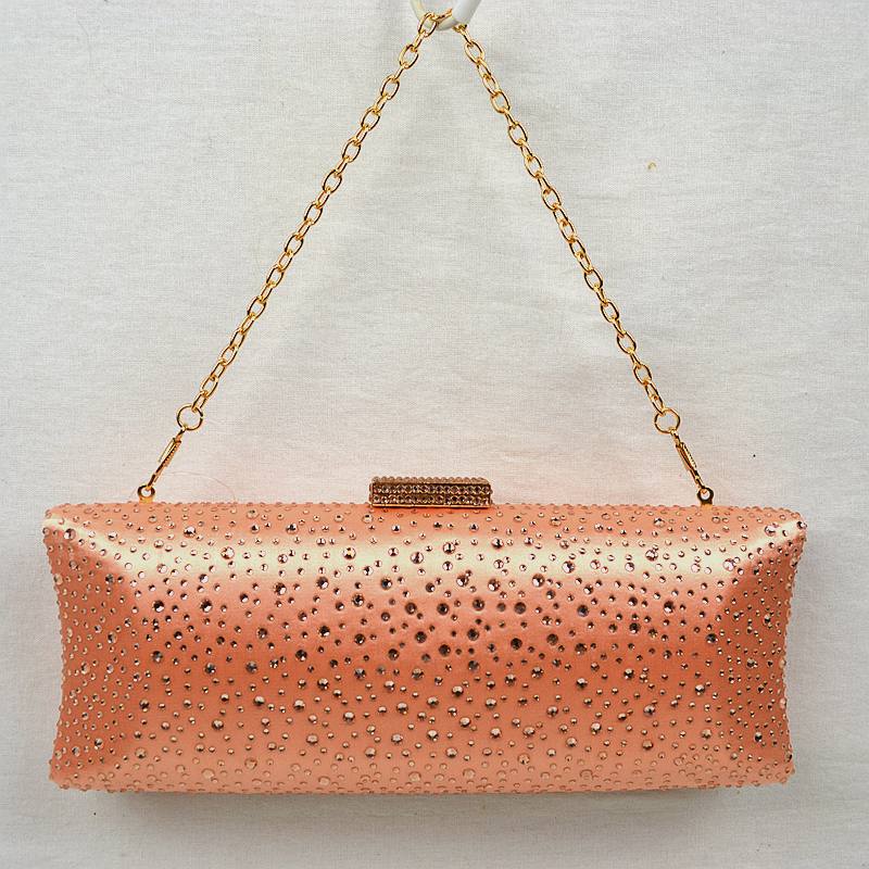 Orange rhinestone-studded evening clutch with gold chain handle and rectangular clasp