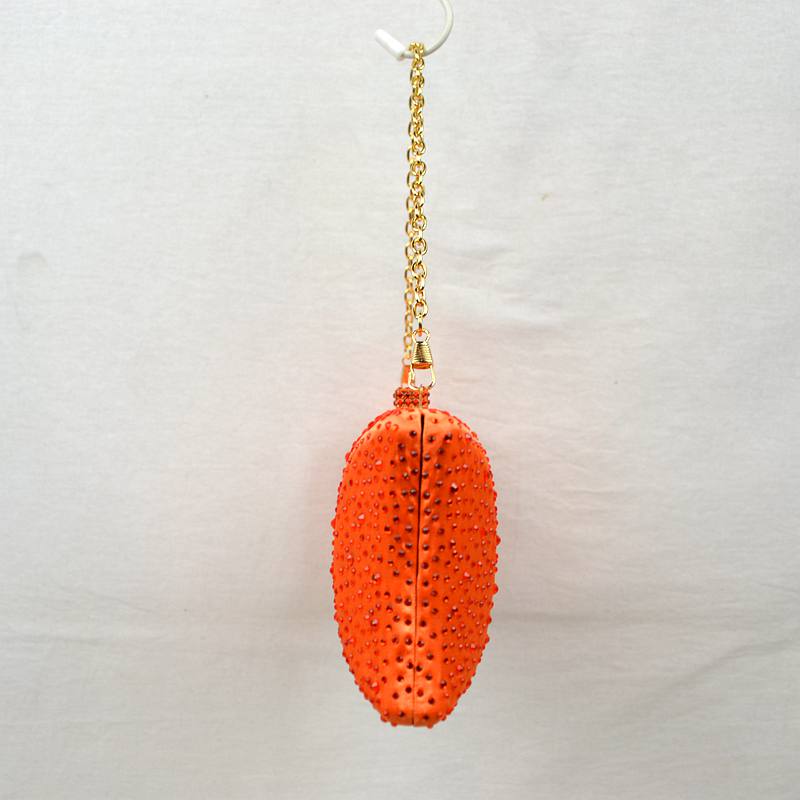 Orange crystal tassel charm on gold chain for studded clutch bag