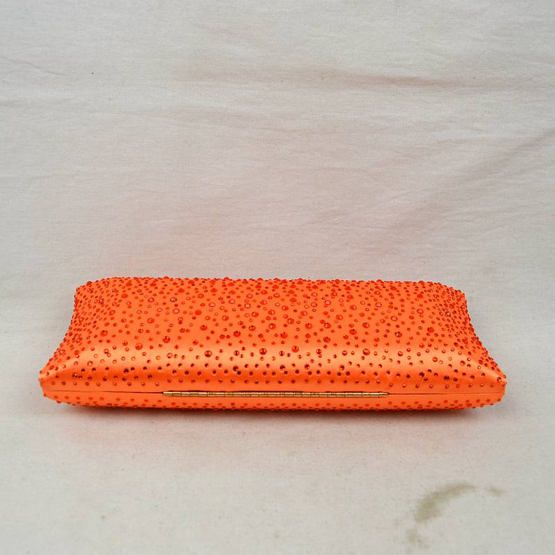 Orange studded crystal clutch bag with top clasp, side view