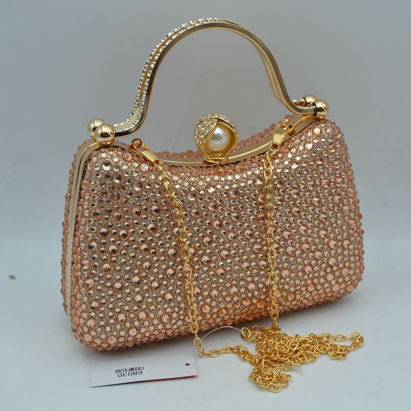 Peach rhinestone evening clutch with pearl clasp, gold-tone handle, and chain strap