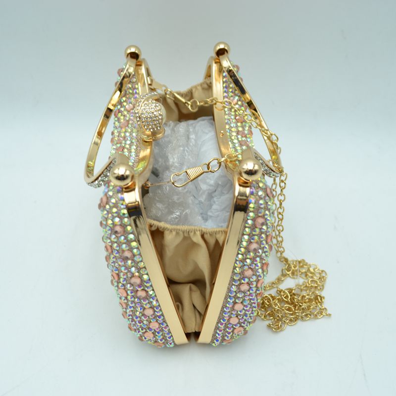 Gold-tone rhinestone evening clutch bag open to show interior and metal clasp