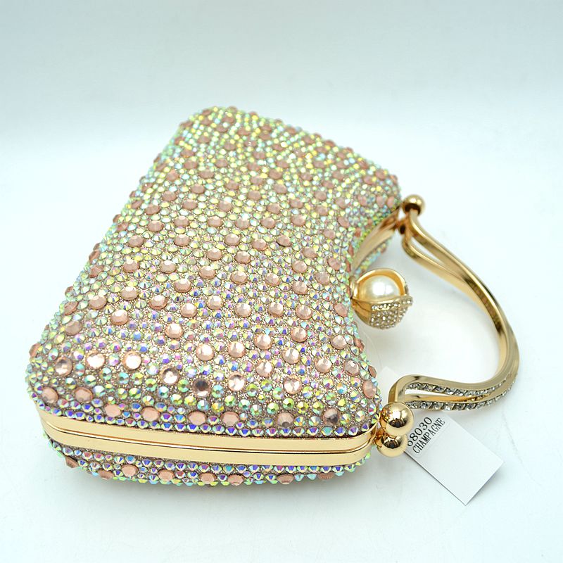 Iridescent rhinestone clutch bag with gold-tone hoop handle and round pearl clasp