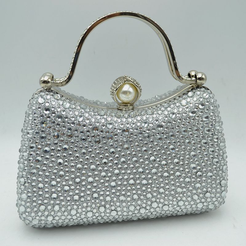 Rhinestone evening clutch bag with pearl clasp and curved metal handle, silver