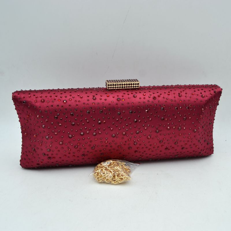 Rhinestone-studded burgundy evening clutch with gold chain strap and top clasp