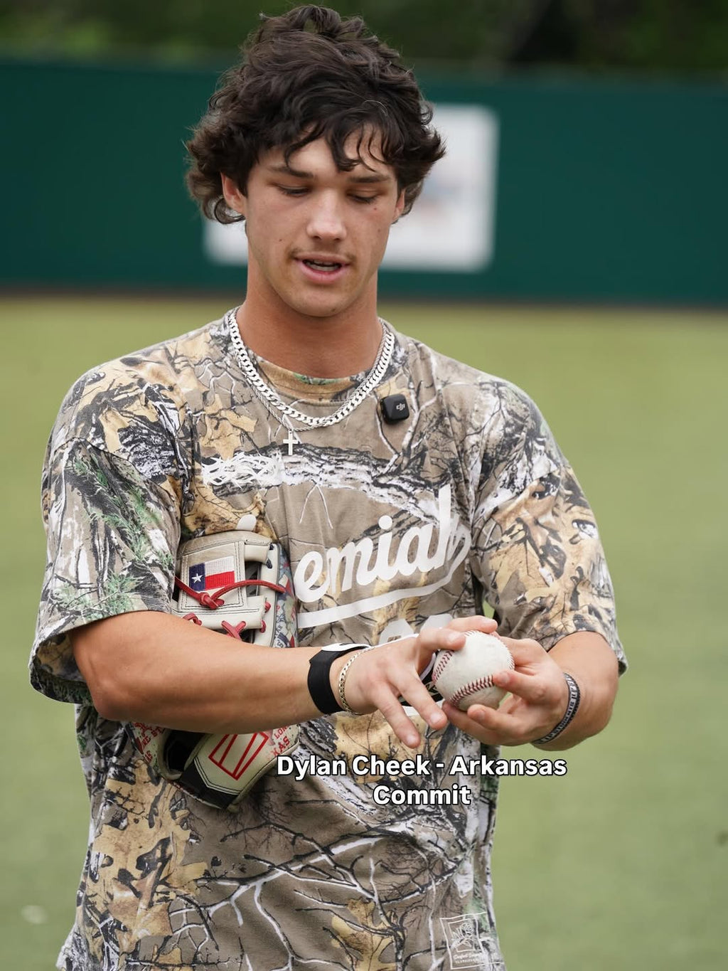 White baseball with red stitches held in hand