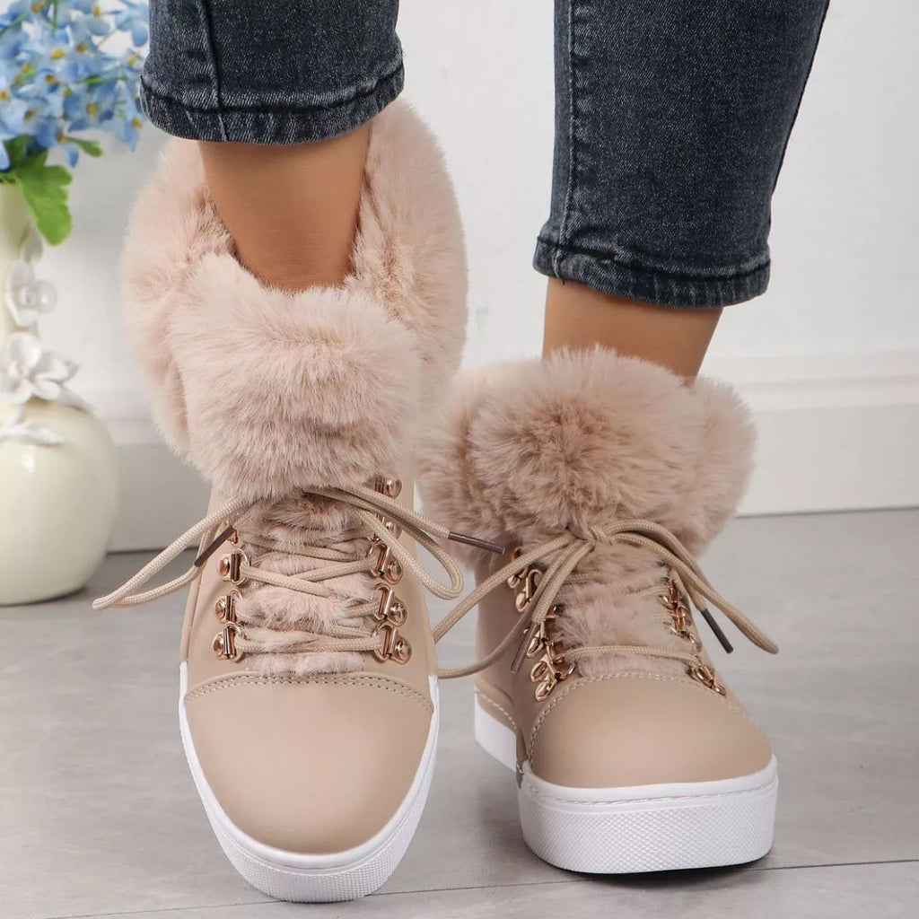Beige lace-up ankle boots with fluffy collar, gold eyelets, and white midsole
