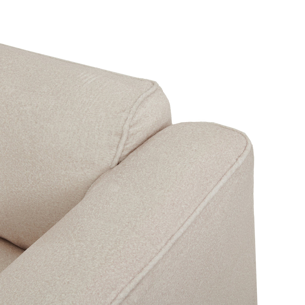 Close-up of light beige armrest and seat cushion with smooth upholstered fabric