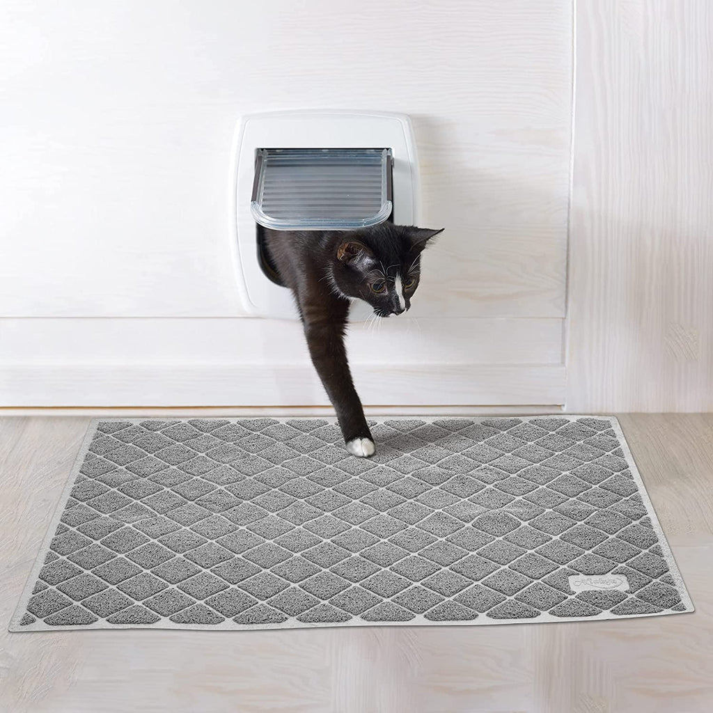 Gray diamond-pattern cat litter mat placed beneath a cat door