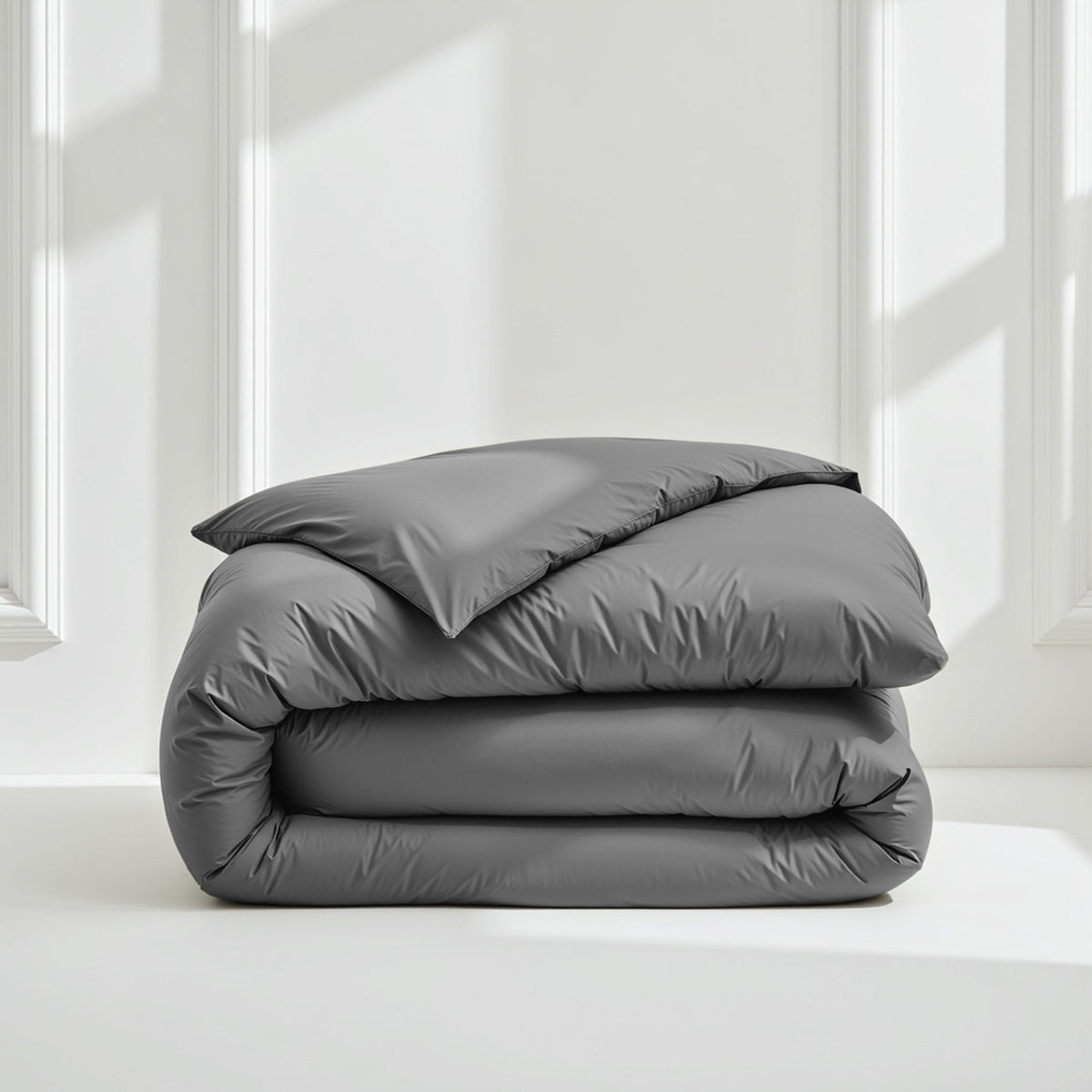 Sateen bedding set with stacked rolled comforter in medium gray color