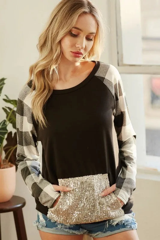 Black French terry top with check raglan sleeves and gold sequin kangaroo pocket