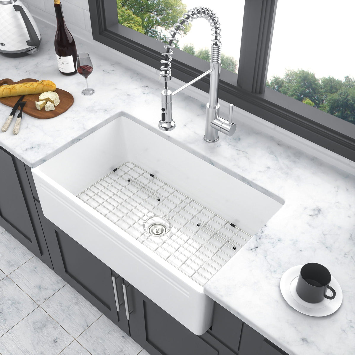 White ceramic single-bowl apron-front sink with rack grid and centered drain