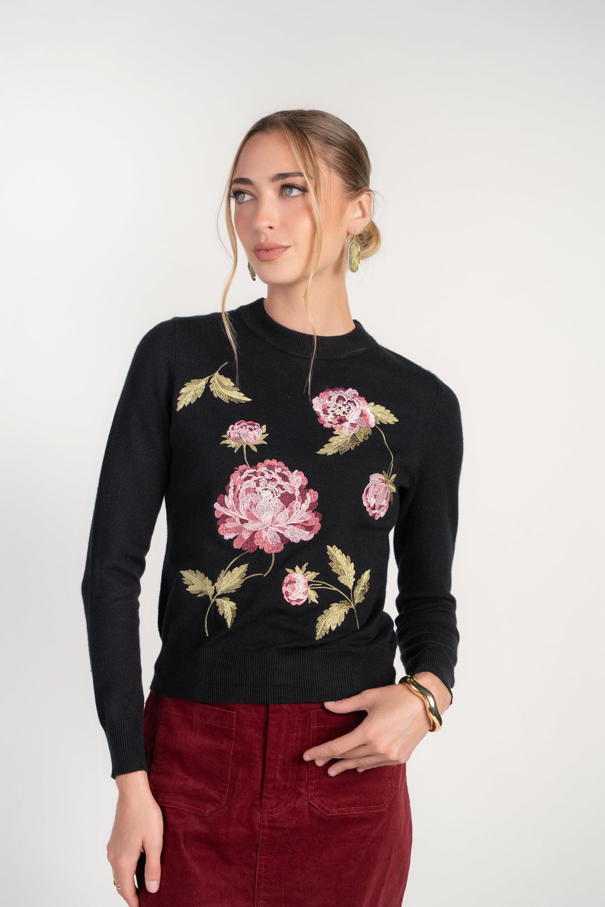 Black crew neck sweater with pink peony-style floral embroidery