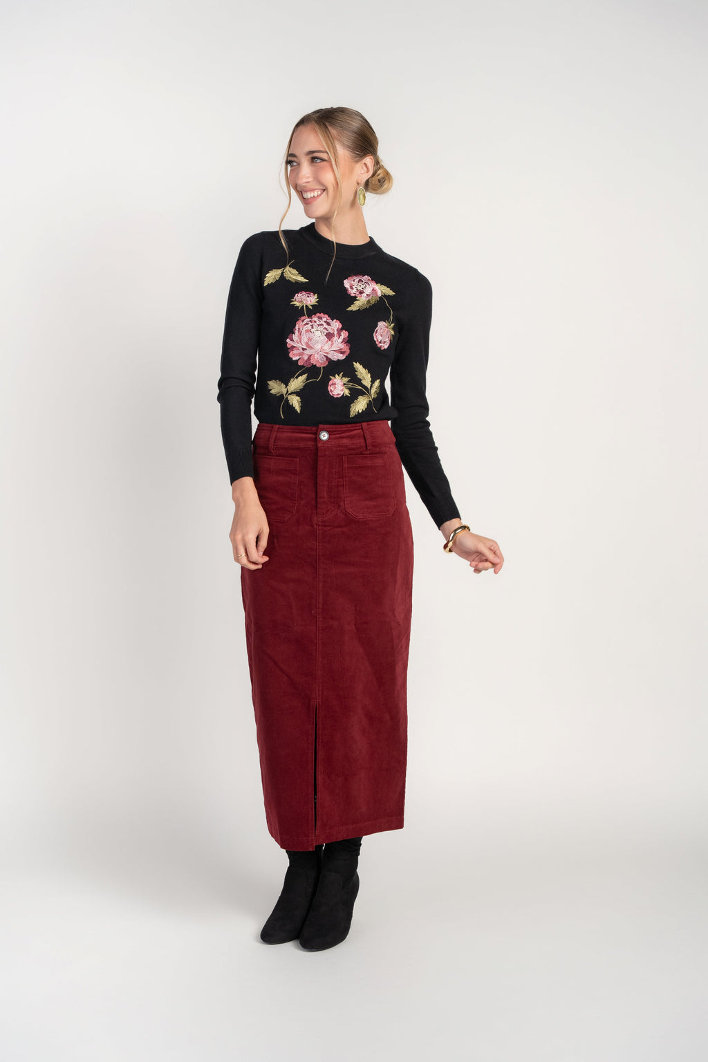 Black crew neck sweater with pink floral embroidery front, long sleeves