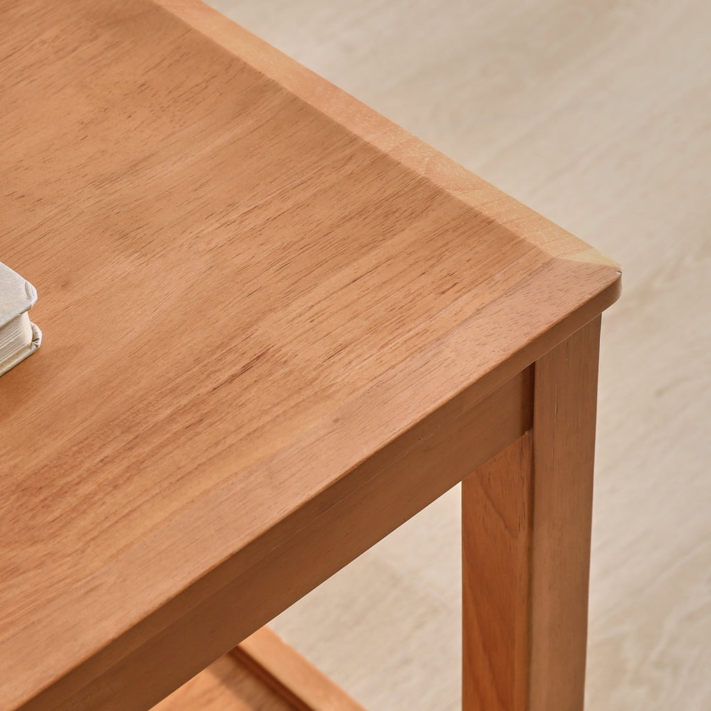 Close-up of the wood side table's smooth top, corner, and sturdy leg