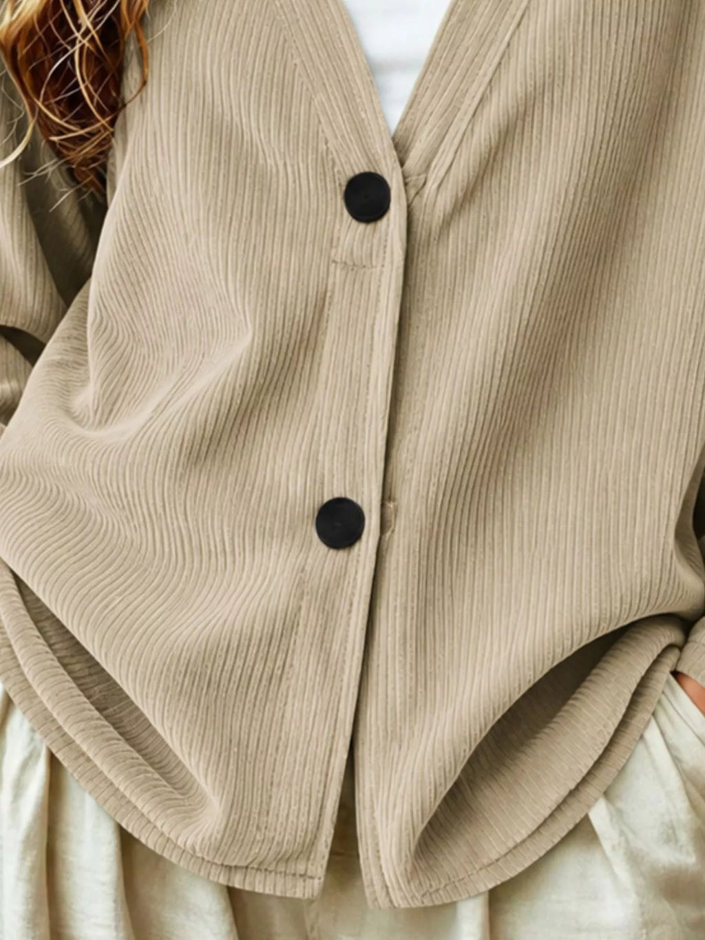 Khaki corduroy button-up cardigan front detail with black button closures