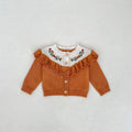 Camel knitted cardigan with white embroidered yoke, ruffled collar, button front, long sleeves