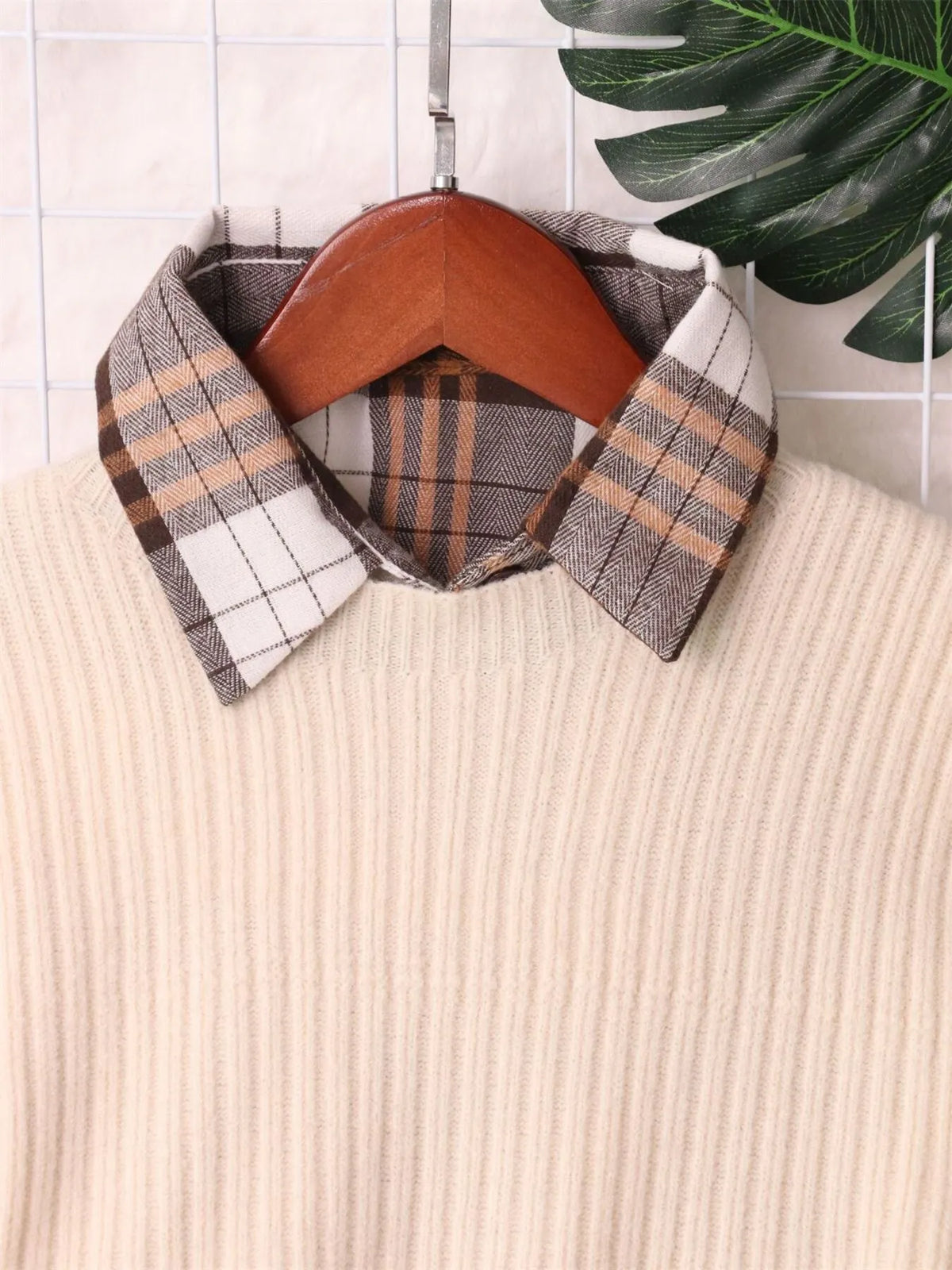 Cream sweater dress neckline with plaid button-up collar and ribbed knit shoulders