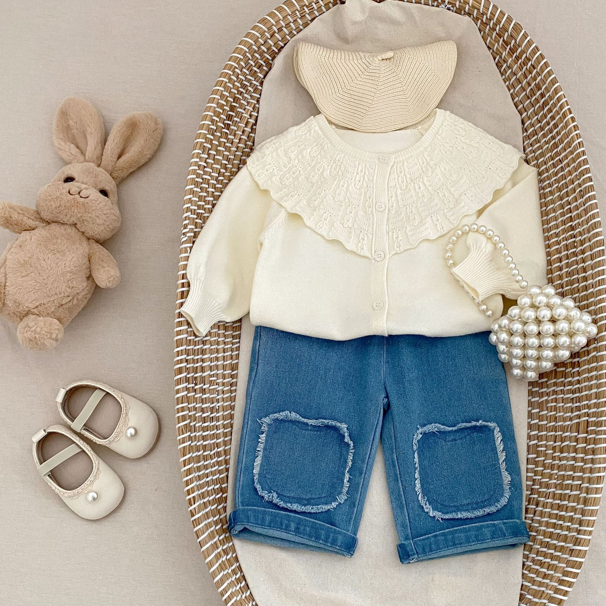 Cream baby knitted coat with textured ruffled collar and button-front, long sleeves