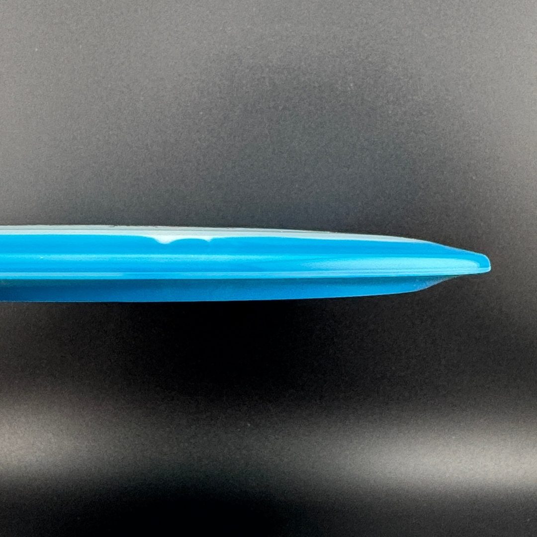 Blue and dark teal disc golf driver, side profile showing smooth rim