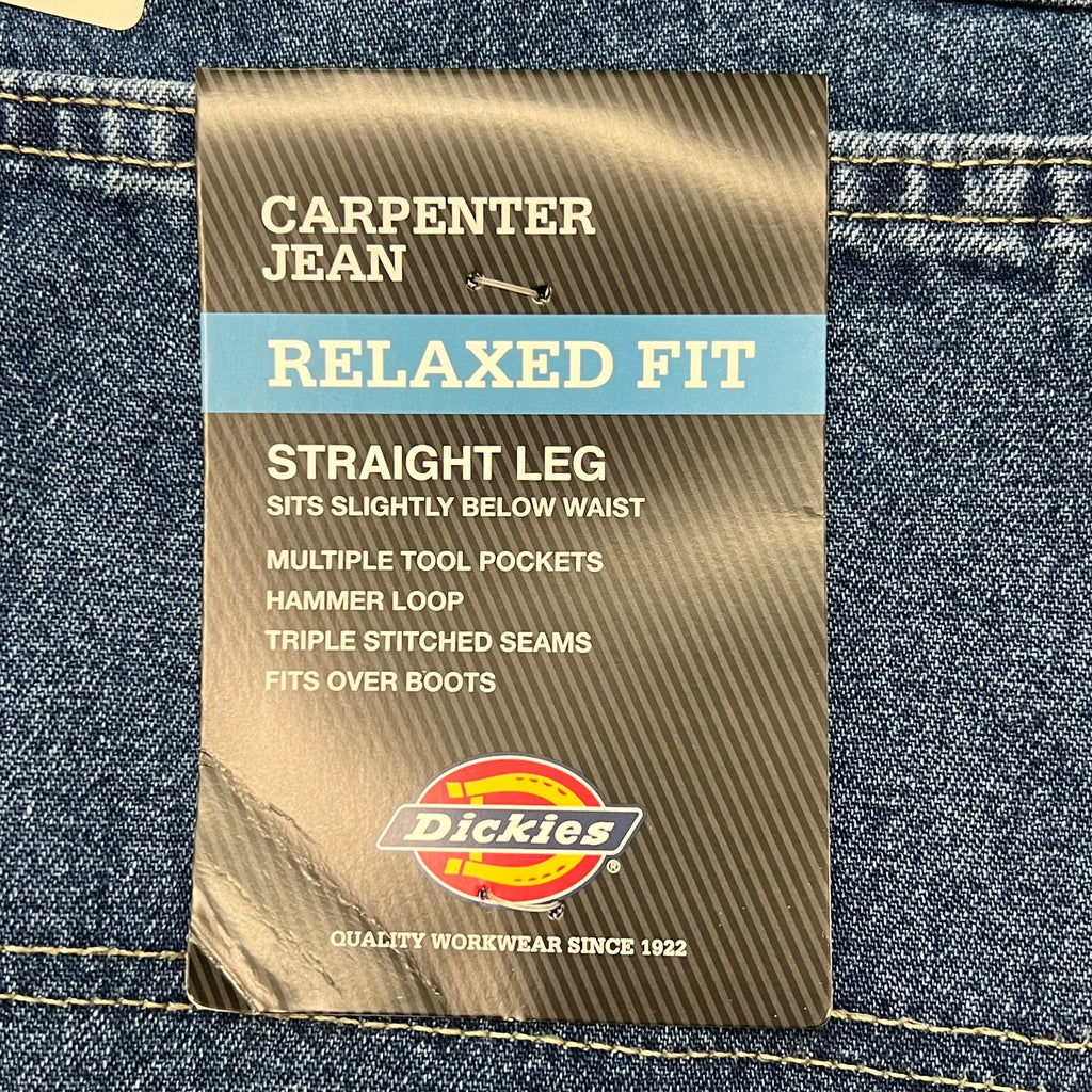 Sewn label at the waistband of indigo blue carpenter jeans.