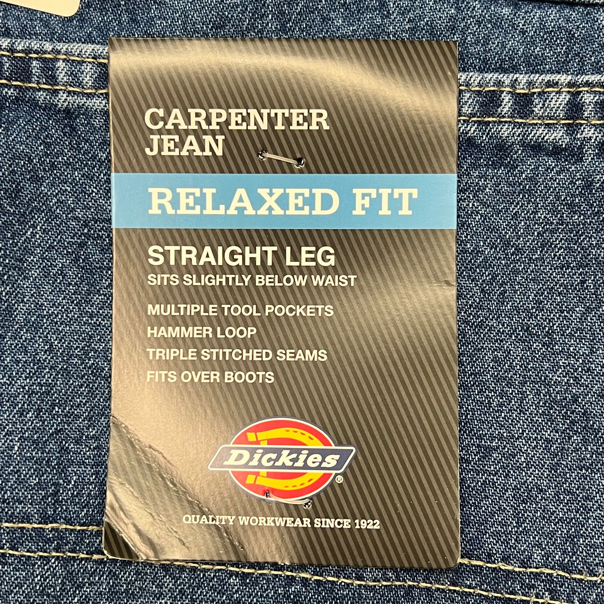 Sewn label at the waistband of indigo blue carpenter jeans.