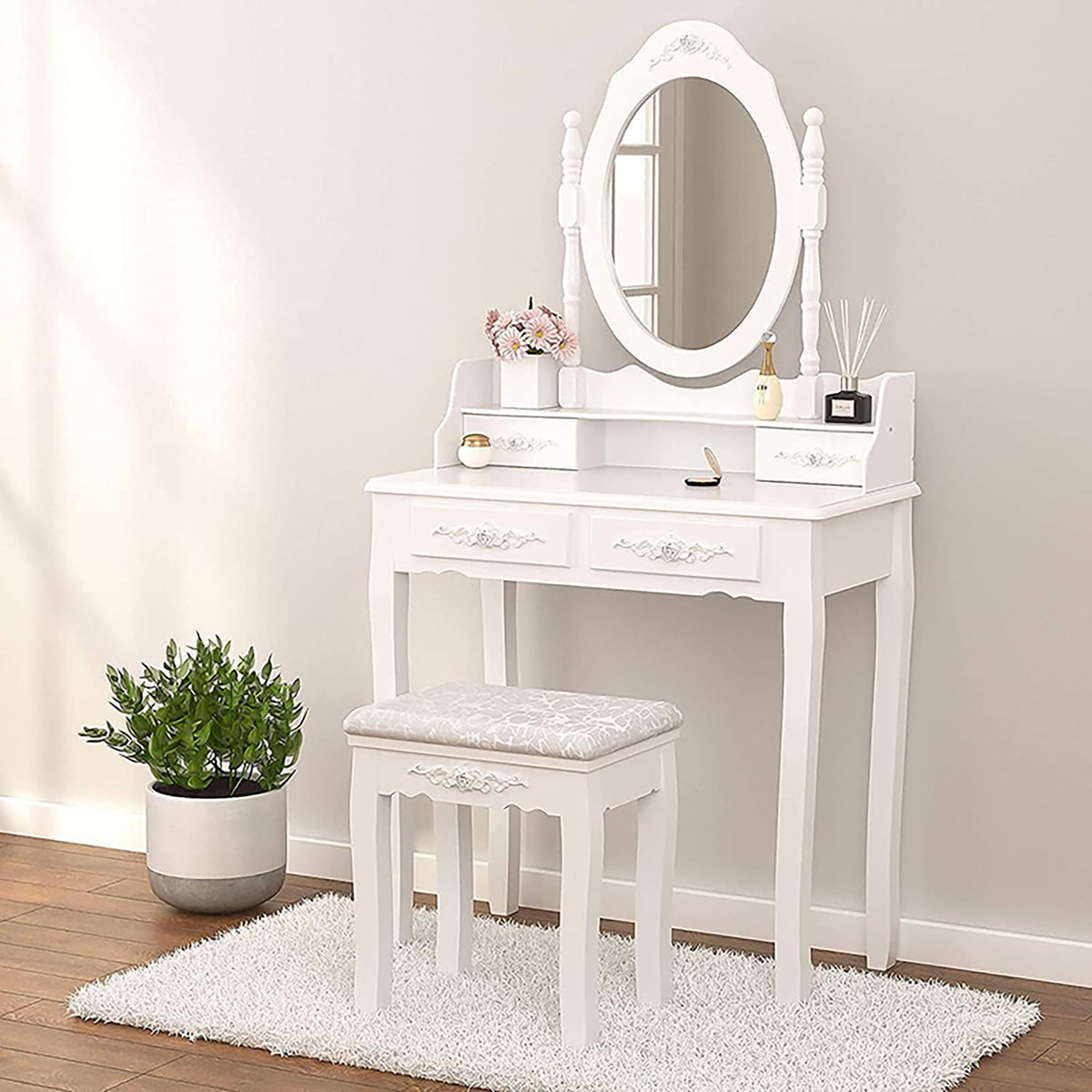 White vanity table set with oval mirror and 4 drawers, plus upholstered cushioned stool