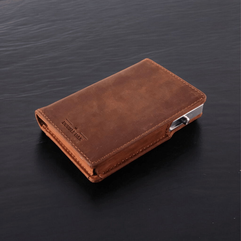Brown leather bifold wallet lying flat with embossed logo on front