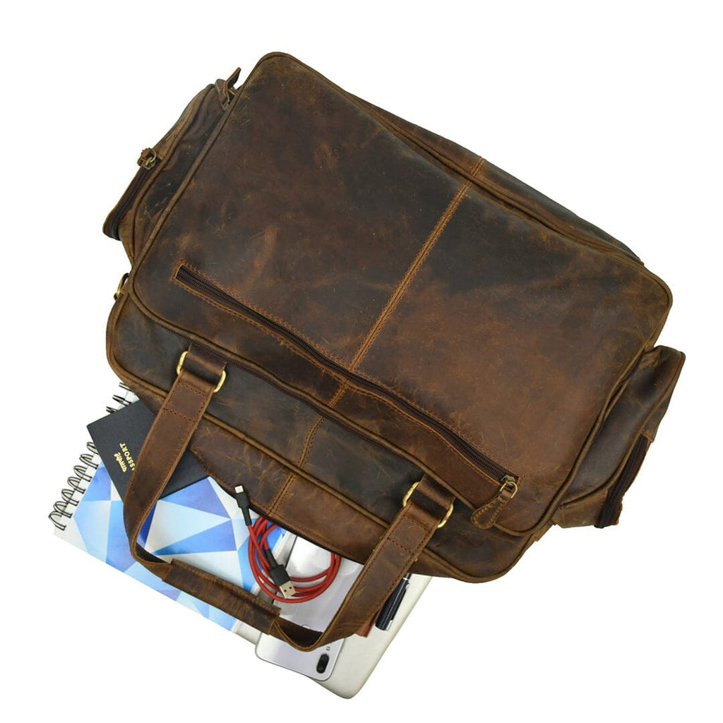 Brown leather briefcase at an angle with front buckle strap and zip pocket