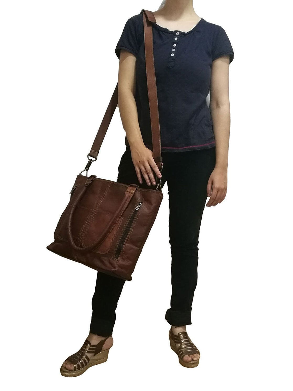 Terry tote bag worn crossbody with brown leather body and front vertical zip pocket