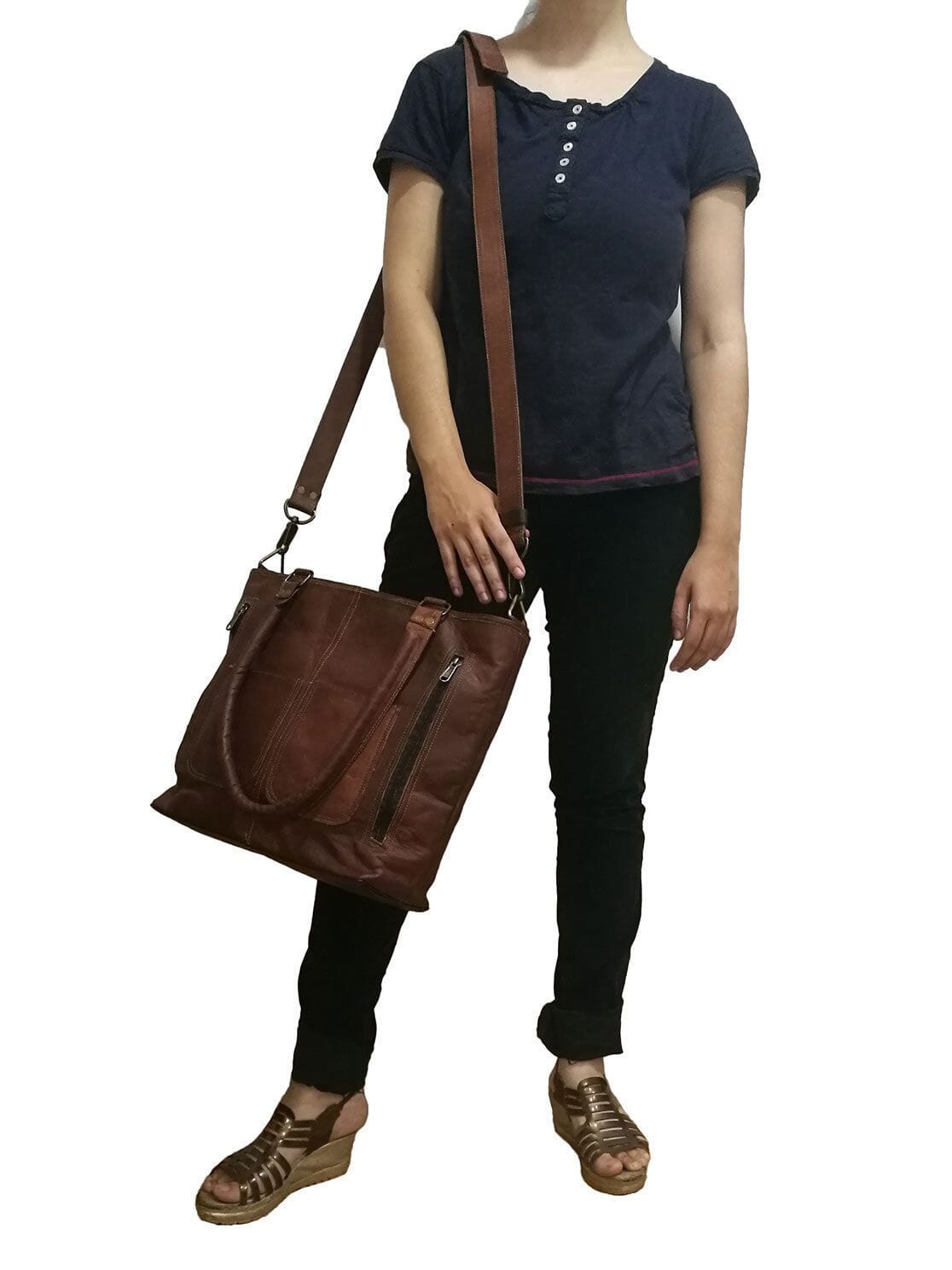 Terry tote bag worn crossbody with brown leather body and front vertical zip pocket