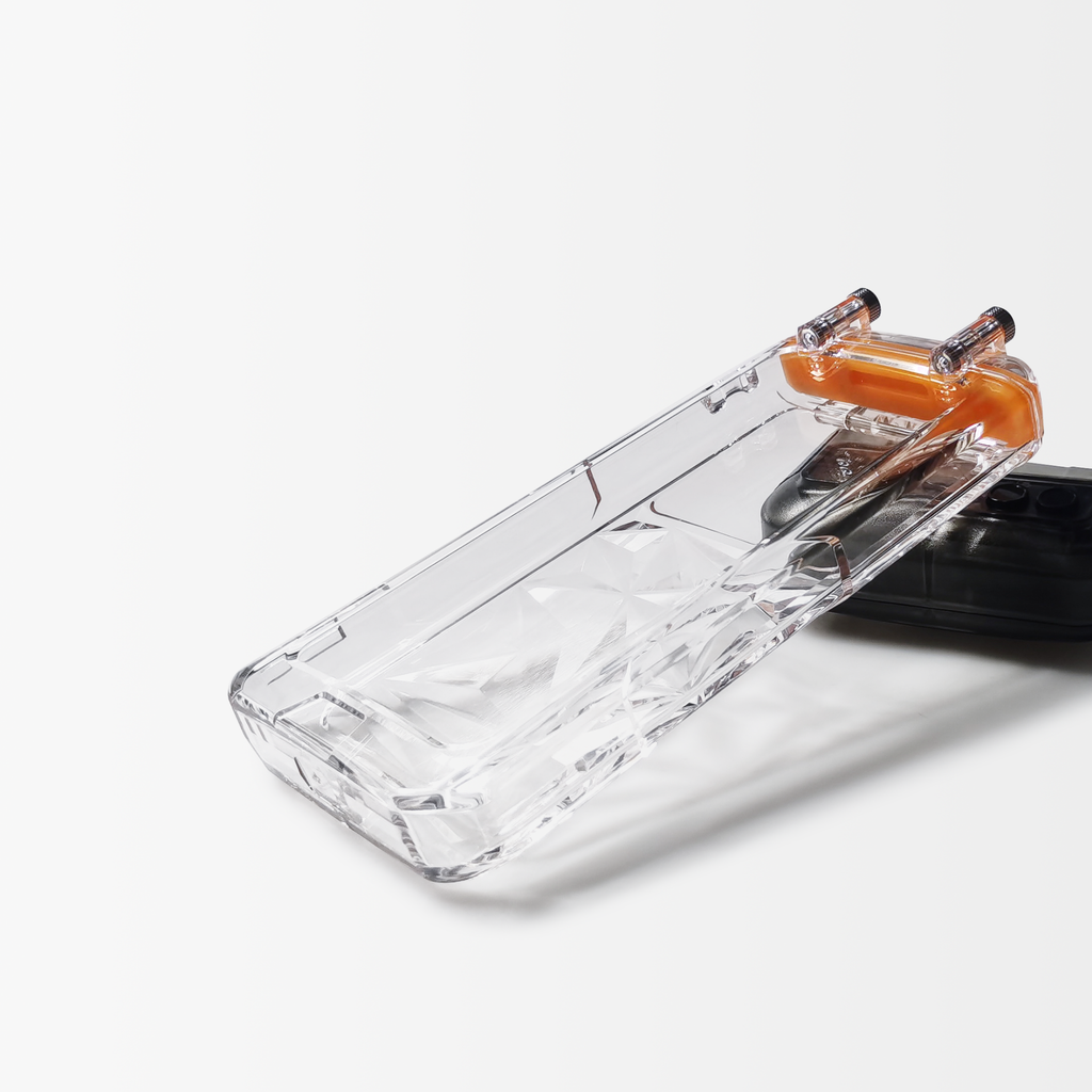 Angled view of clear waterproof phone case with black base and orange control hardware