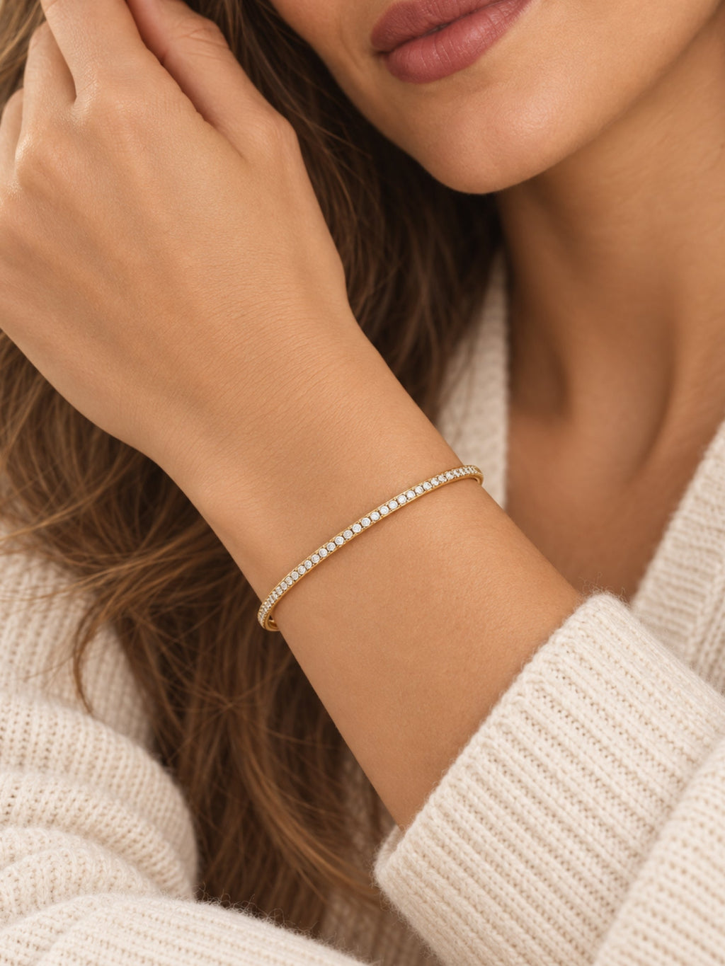 Close-up gold-tone pave cuff bracelet with small round stones along the band