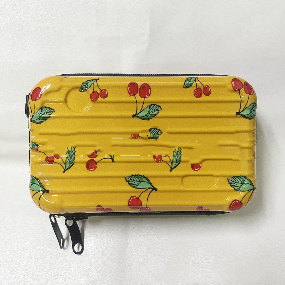 Cosmetic bag with yellow cherry-leaf print and black zipper trim.