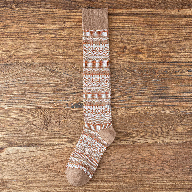 Children’s knee-length socks in beige with terracotta and cream stripe pattern.