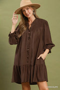 Chocolate-brown tiered mini dress with ruffle-trimmed neckline and long puff sleeves.