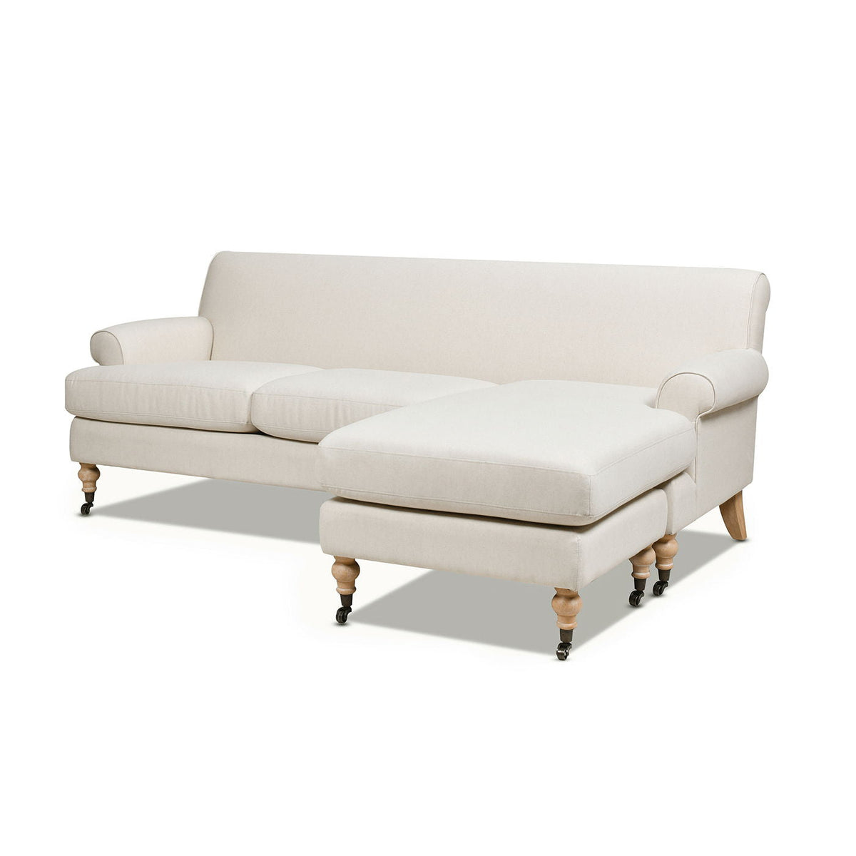 Light beige sectional sofa with chaise, tufted-look cushions, and turned wood feet