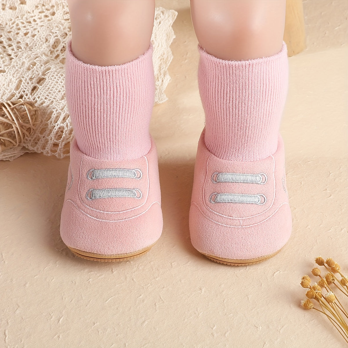 Pink baby sock booties with bear face, front lace detail, and ribbed cuffs