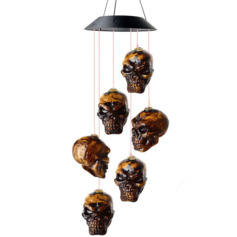 Skull solar LED wind chime with black top and six hanging skull ornaments
