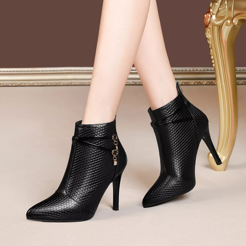 Black pointed-toe stiletto ankle boots, textured upper and side chain charm accents