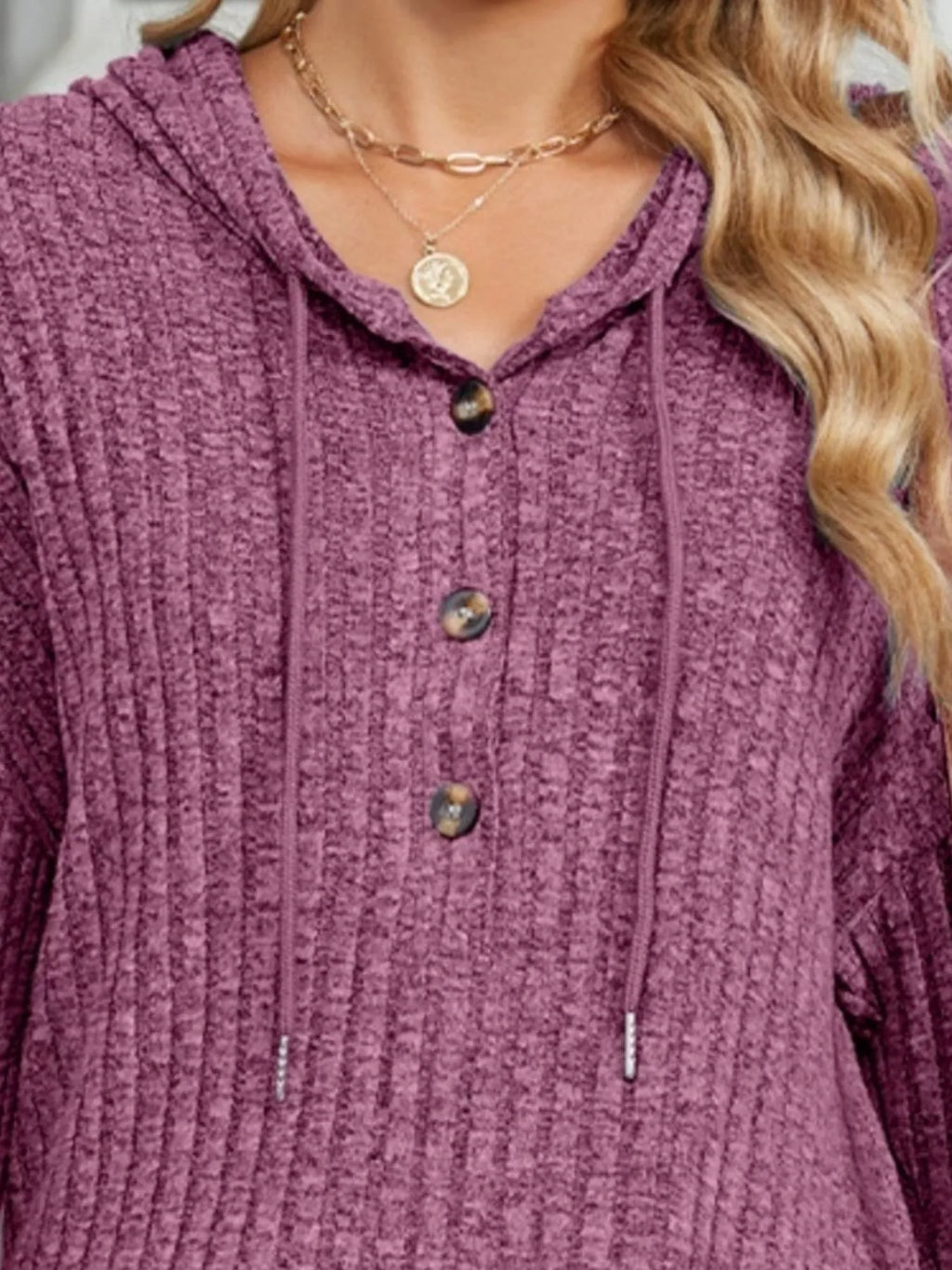 Ribbed knit hoodie with hood, drawstring, and button placket in purple.