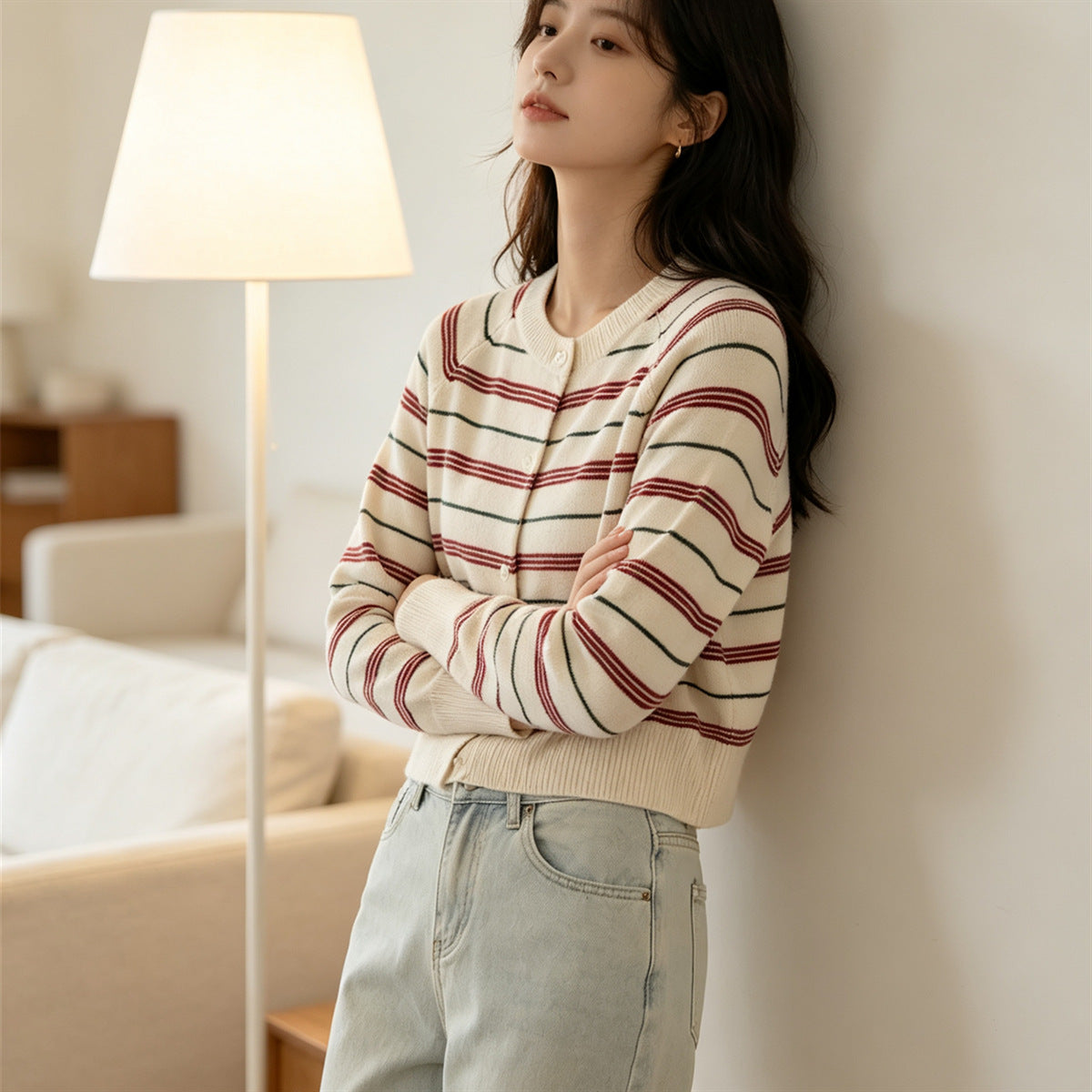 Cream striped cardigan with button front, long sleeves, contrasting red and dark stripes