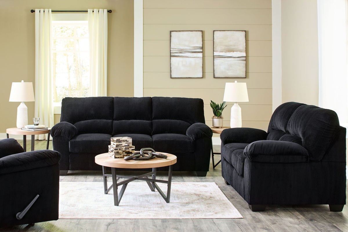 Dark navy sofa with matching recliner chair and tufted seat