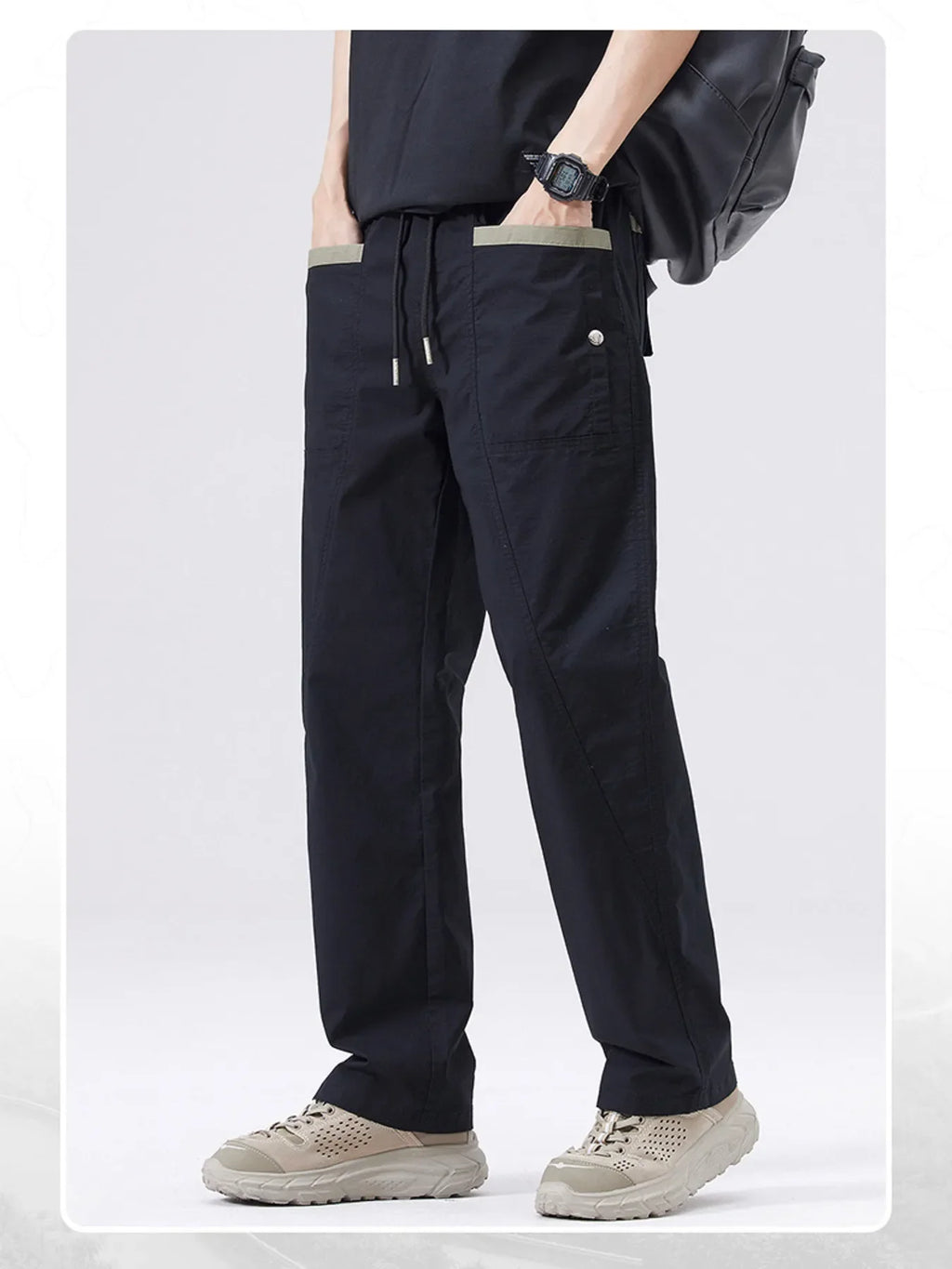 Men's black drawstring cargo pants with cargo pocket detail and ankle cuffs.